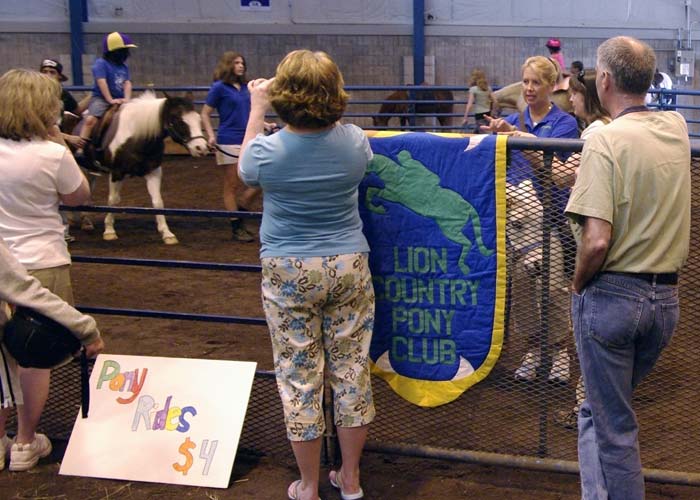 Lion Country Pony Club banner and people